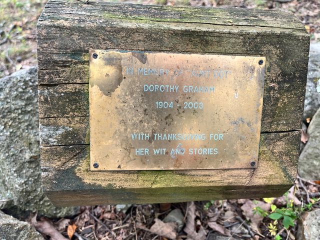 A weathered memorial plaque for Dorothy Graham.