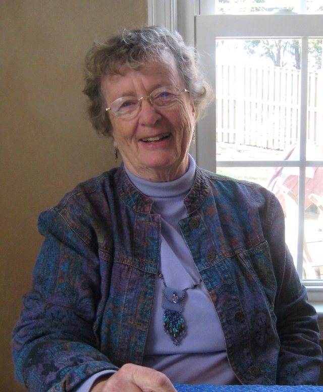 Reverend Margee Iddings smiling at a table